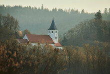 Sunrise Above The Church Of Tegernheim With Bushes And Bare Trees In The Morning Light; Tegernheim, Bavaria, Germany