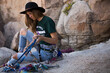 © Designpics - A young woman racks up for a climb in Joshua National Park.