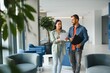 © Serhii - Two business coworkers walking through a lobby of an office building