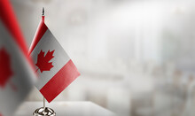 Small Flags Of The Canada On An Abstract Blurry Background