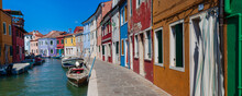 Colorful Houses Along The Waterfront Canal On Burano Island In Veneto; Venice, Italy