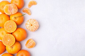 Wall Mural - Fresh juicy tangerines on light grey table, flat lay. Space for text