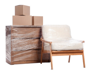 Wall Mural - Boxes, armchair and chest of drawers wrapped in stretch film on white background