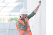 © ND STOCK - Supervisor male engineer wearing a protective vest and safety hard hat.in construction site for building site survey in civil engineering project.