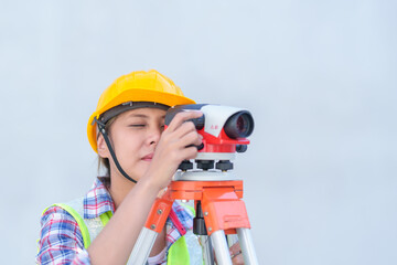 Wall Mural - Female survey working Using Theodolite Surveying Optical Instrument for Measuring Angles in Horizontal and Vertical Planes on Construction Site.