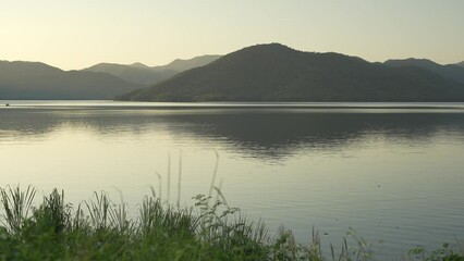 Wall Mural - Mountain Nature landscape around reservoir and warm evening time moment