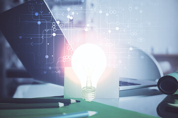 Poster - Computer on desktop in office with bulb icon hologram. Multi exposure. Concept of idea.