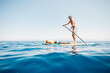 © Connect Images - USA, California, Father and son paddleboarding on calm Lake Tahoe