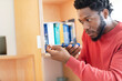 © Connect Images - Young man repairing cupboard with screwdriver at home