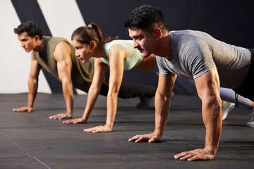 Wall Mural - young athletic man doing push up with on the gym floor