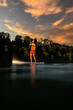 © lightpoet - Handsome young man on a paddle board. Getting a great exercise on a lovely river in warm evening sunlight