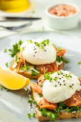Wall Mural - Poached egg with salmon and guacamole on toast. Delicious breakfast. Food recipe background. Close up