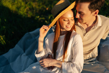 Wall Mural - portrait of happy young couple in love sitting hugging with closed eyes enjoying their time together
