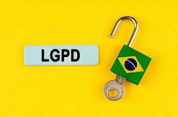 Poster - On the yellow surface is an open lock with a key and a sticker with the inscription - LGPD