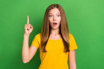 Poster - Photo of impressed clever girl open mouth point finger great idea isolated on green color background