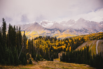 Landscape of sceneic views in Telluride, Colorado in the fall with colorful aspen trees, gondola, and purple mountain background