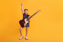 Cute Girl With Electric Guitar On Orange Background