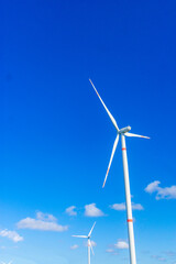 two windmills with a blue sky at the south east coast. Concept of renewable energy