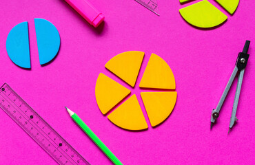 Wall Mural - School stationery, fractions, rulers, pencils on magenta background. Back to school, fun education concept. Set of supplies for mathematics and for school. Close up