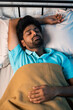 © WESTOCK - top view vertical shot of peacful young man sleeping during night - concept of relaxation, napping and wellness
