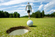 © areporter - Hole on the golf course, next to a white ball