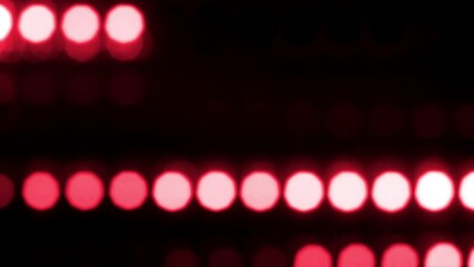 Wall Mural - Red Dotted lines motion with depth of field effect. Defocused bokeh lines moving horizontally. Glowing circles with trail moving across the frame. Abstract led light disco wall.