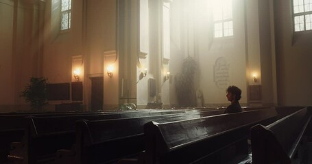 Wall Mural - Spiritual Man Sitting and Praying in the Church. Parishioner Feeling the Connection to the God. Belief Goodness and Kindness through Religion and Spirituality. Contemplation in Christian Cathedral