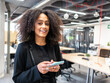 © ADDICTIVE STOCK - Positive black female using smartphone in modern office