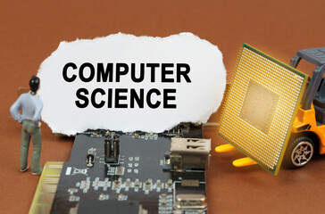 Poster - On the board with microcircuits lies a paper plate with the inscription - Computer Science