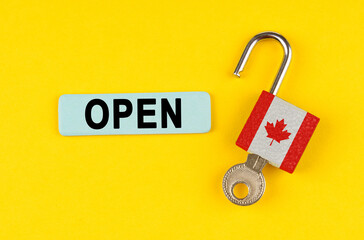 Poster - On the yellow surface is an open lock with a key and a sticker with the inscription - open