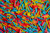 Fototapeta Tęcza - Macro photography of long colored candies. Candy concept.
