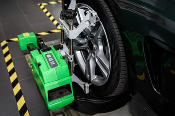 Balancing wheel in service center. Special professional equipment for wheel alignment