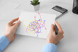 © Pixel-Shot - Woman holding paper sheet with drawn arrows at office table, closeup. Concept of choice