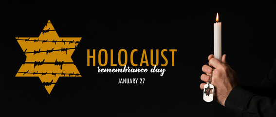 Banner for International Holocaust Remembrance Day with praying Jewish man holding candle on dark background