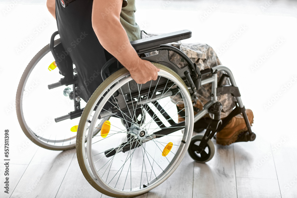Young soldier in wheelchair at home