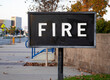 Black sign with white letters stating the word Fire for Fire Department