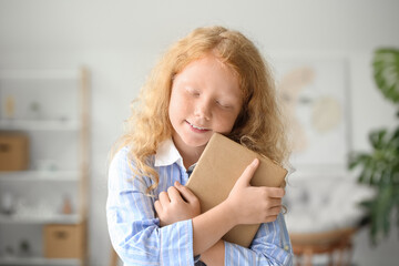 Sticker - Little redhead girl with old book at home