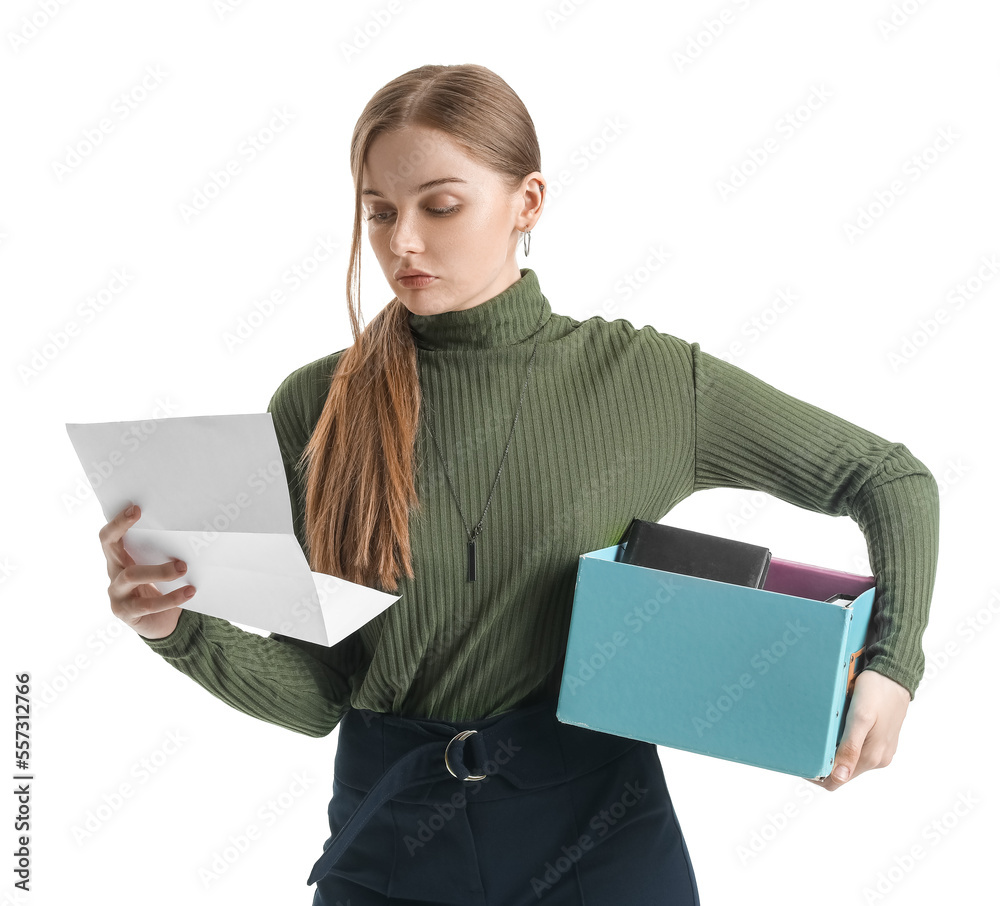 Fired young woman with order for her dismissal and packed stuff on white background