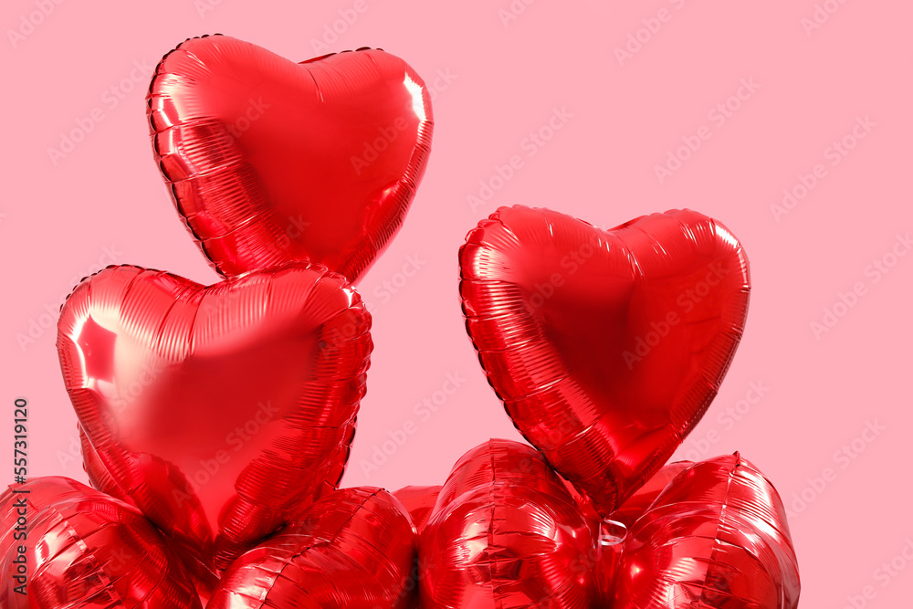 Heart-shaped balloons for Valentine's Day on pink background
