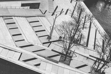 Black and white photo of stairs, lines and few people