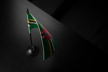  Small national flag of the Dominica on a black background