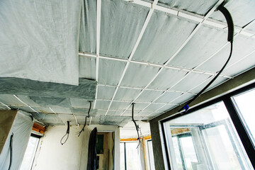 Insulation and ceiling lining with heat-insulating and energy-saving materials. Fragment of the room in the process of construction and decoration. Inside view. selective focus