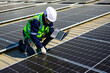 © 1st footage - Engineer technician using laptop checking and operating system on rooftop of solar cell farm power plant, Renewable energy source for electricity and power, Solar cell maintenance concept