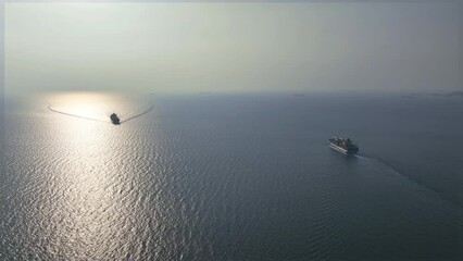 Wall Mural - Aerial view of cargo ship carrying container in ocean.