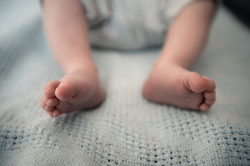 Wall Mural - close-up on cute feet of a small newborn baby, babyboy, love