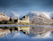 Scotland United Kingdom. , Kilchurn Castle, Loch Awe near Oban in the Scottish Highlands. Historic castle reflected in the loch with snowy winter mountain backdrop. 