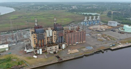 Wall Mural - Old thermal power station located on coast of bay in process of being decommissioned