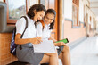 © Odua Images - two asian high school students doing homework together at school