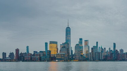Fototapete - Downtown Manhattan skyline at dusk, New York city, timelapse of day to night transition, panning effect