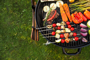 Wall Mural - Delicious grilled vegetables on barbecue grill outdoors, top view. Space for text